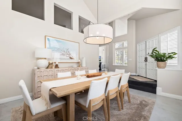 a view of a dining room with furniture and a chandelier