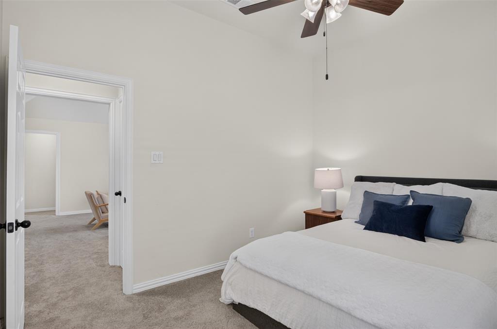 842 Sun Meadow Road Allen, TX 75013 - Photo 24 of 39 Carpeted room with a ceiling fan featuring wood-finish blades and integrated lighting