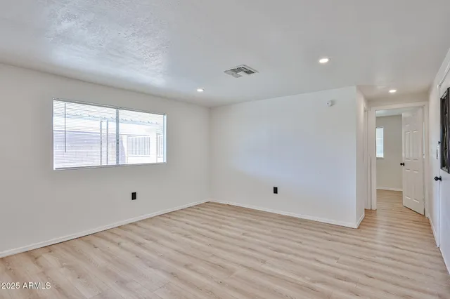 a view of room with wooden floor and window