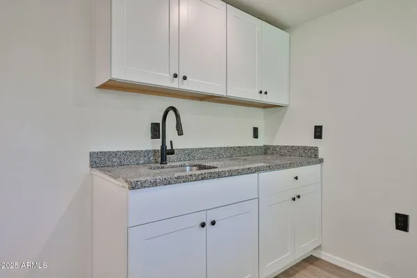 a close view of a sink and cabinets