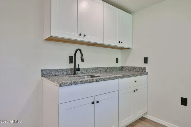 a close view of a sink and cabinets