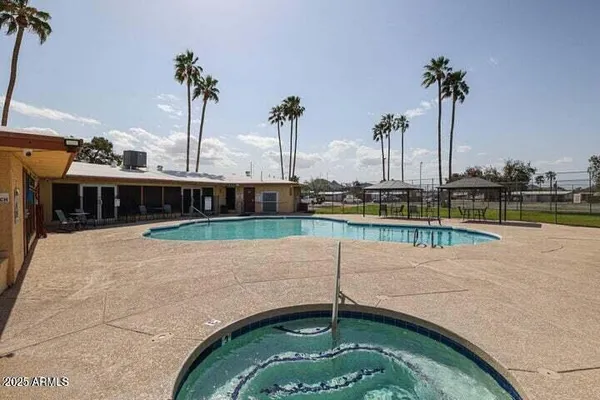 a view of a swimming pool with a lawn chairs