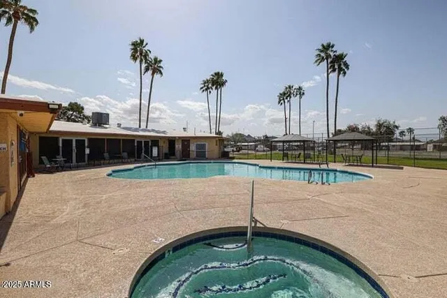 a view of a swimming pool with a lawn chairs
