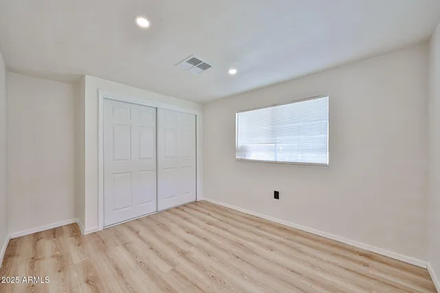a view of room with wooden floor and fan