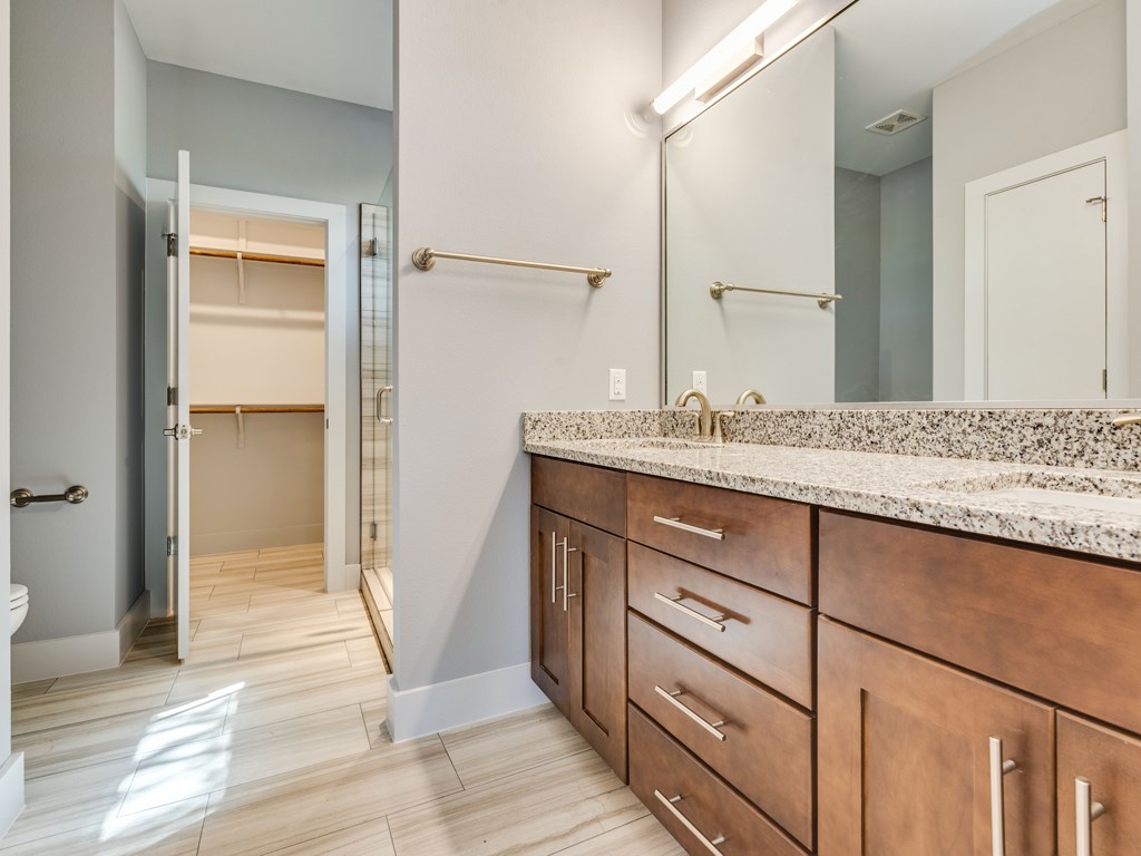 406 Post Rd Drive, Unit 1 Austin, TX 78704 - Photo 10 of 30 Primary bathroom with dual vanities, beautiful cabinetry and view of walk in closet