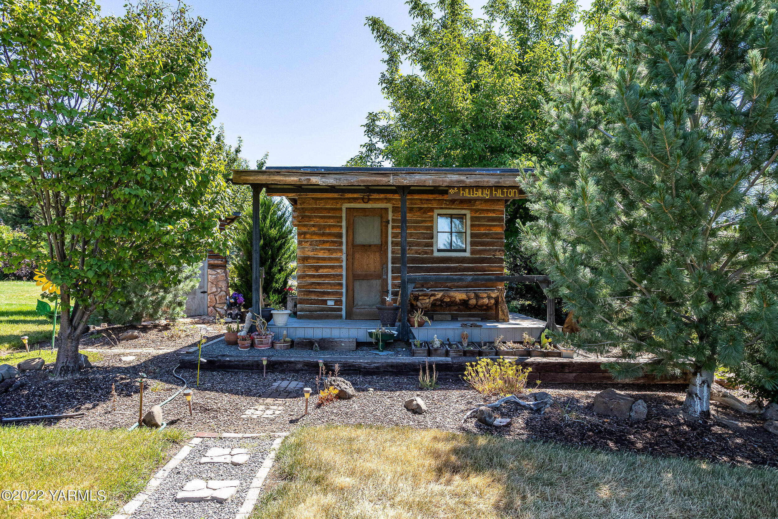 7401 Bittner Road Yakima, WA 98901 - Photo 32 of 55 a view of house with backyard outdoor seating and trees