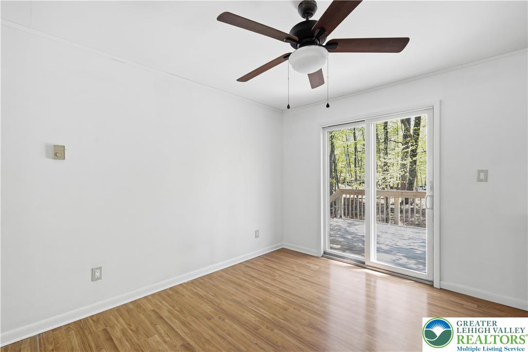 505 Chipmunk Road Bushkill, PA 18324 - Photo 6 of 46 an empty room with wooden floor and windows