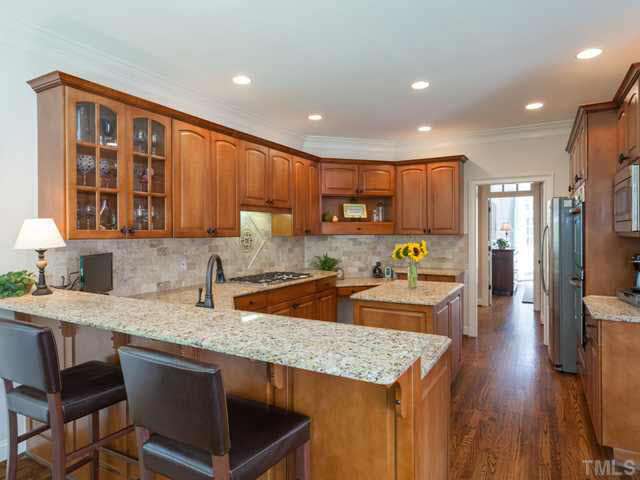 4612 White Chapel Way Raleigh, NC 27615 - Photo 11 of 25 The kitchen enjoys a long breakfast bar that is perfect for barstools and casual dining.