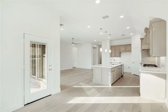 a kitchen with stainless steel appliances granite countertop a stove a sink a refrigerator and a microwave