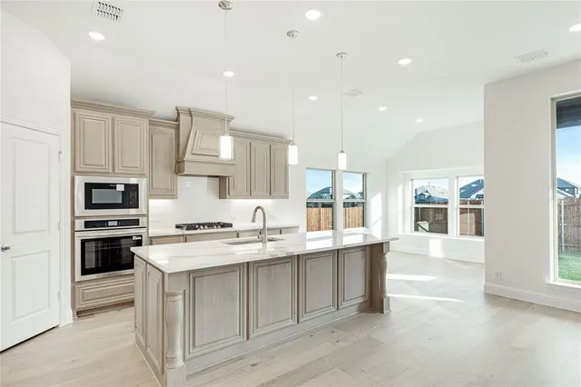 an empty room with windows and ceiling fan
