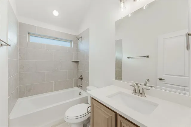 an empty room with wooden floor and fan