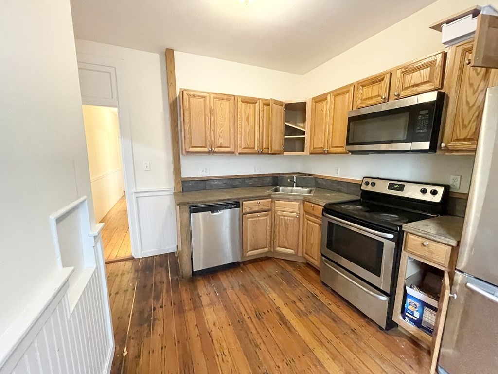 1 Folsom Avenue, Unit 1 Boston, MA 02120 - Photo 2 of 10 a kitchen with a sink a microwave a stove and refrigerator