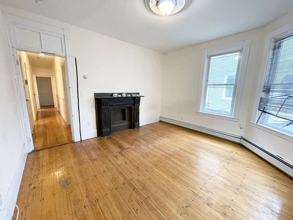 1 Folsom Avenue, Unit 1 Boston, MA 02120 - Photo 3 of 10 a view of a room with wooden floor and window