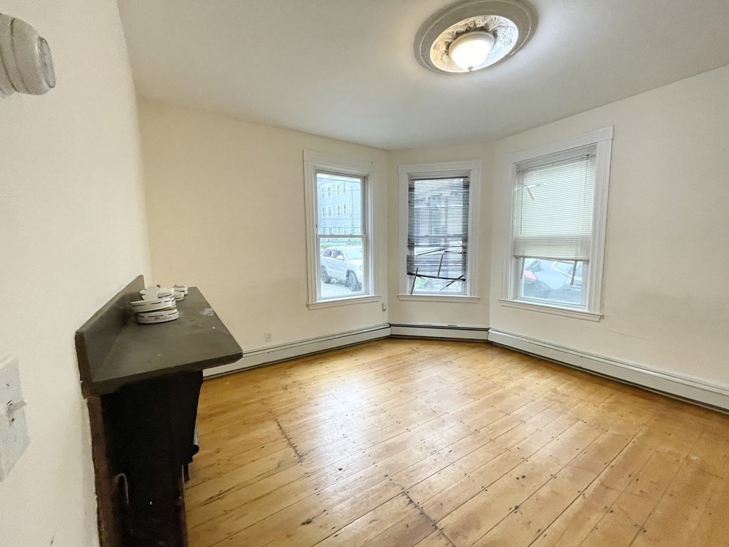 1 Folsom Avenue, Unit 1 Boston, MA 02120 - Photo 6 of 10 a view of a livingroom with wooden floor and a window