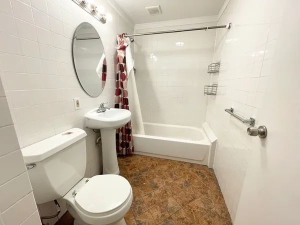 a bathroom with a sink a toilet and a mirror