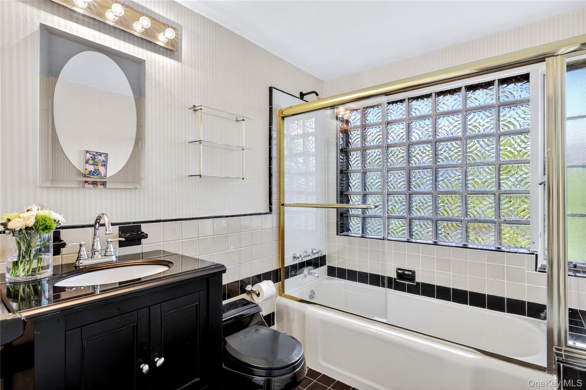 142 Mill Spring Road Manhasset, NY 11030 - Photo 13 of 23 a bathroom with a sink a toilet and a mirror