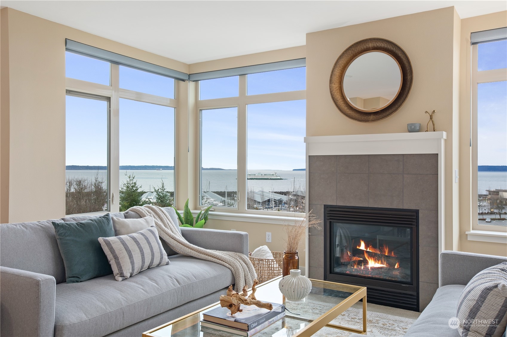 a living room with furniture a fireplace and a large window