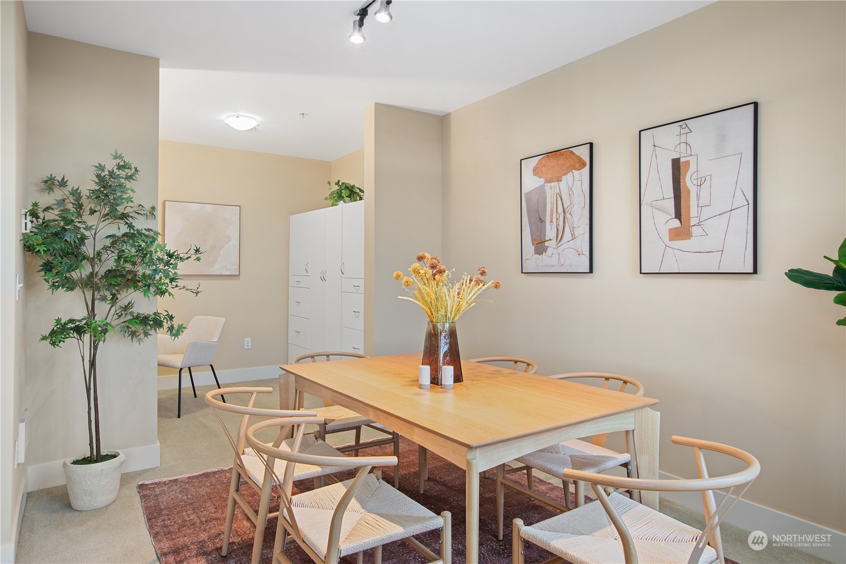 51 Pine Street, Unit 104 Edmonds, WA 98020 - Photo 13 of 40 a view of a dining room with furniture and potted plant