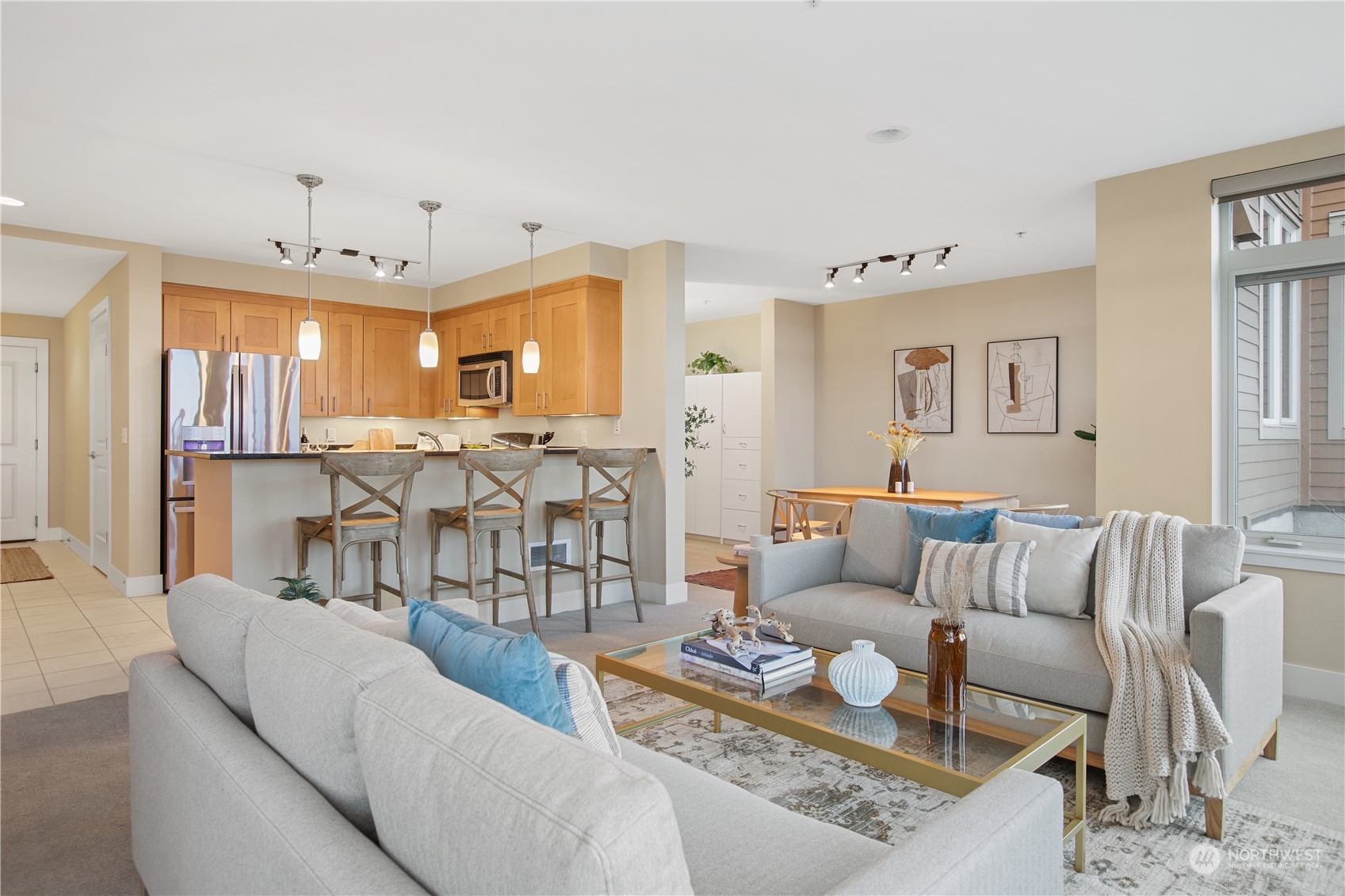 51 Pine Street, Unit 104 Edmonds, WA 98020 - Photo 19 of 40 a living room with furniture kitchen view and a chandelier