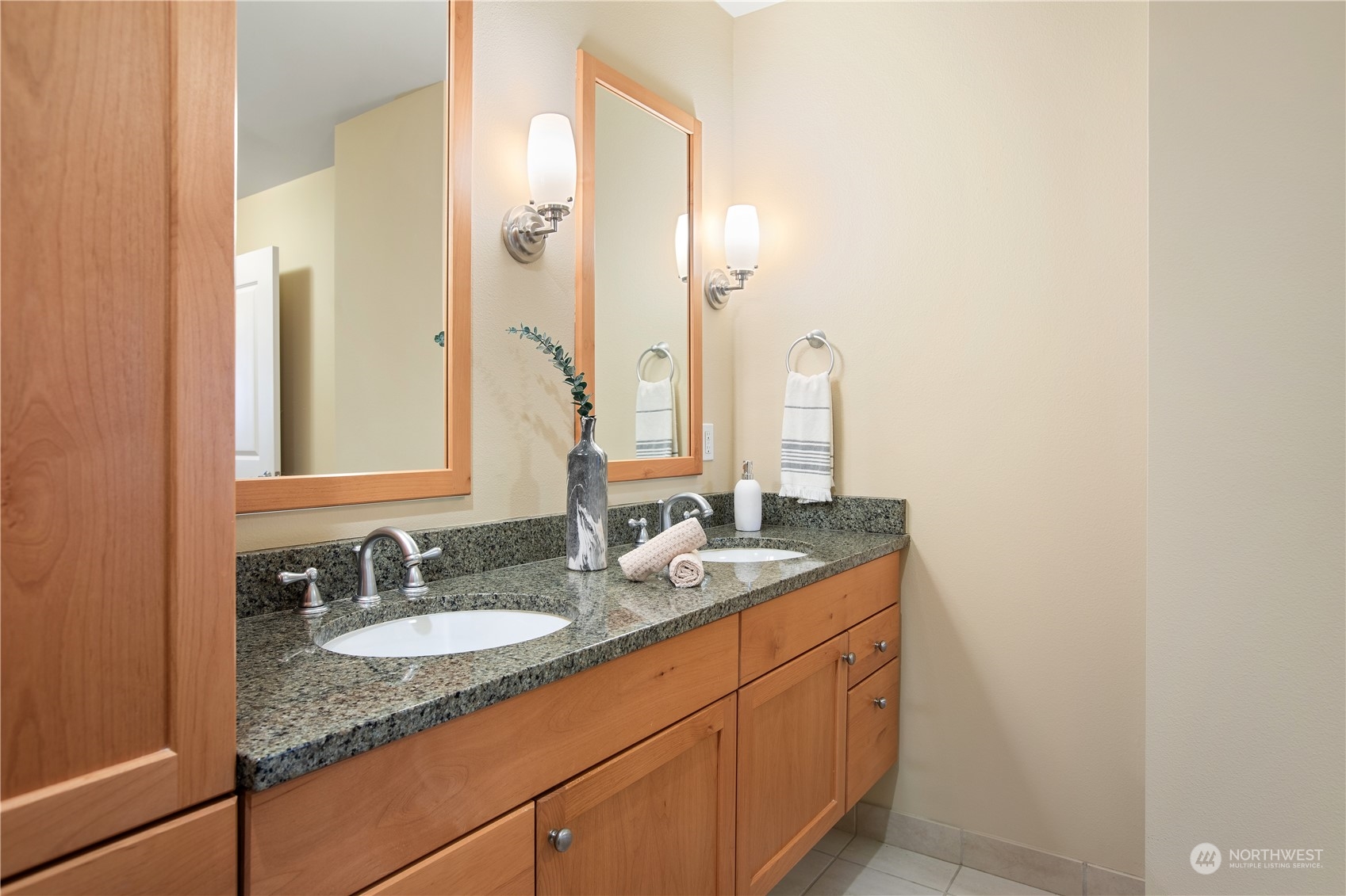 51 Pine Street, Unit 104 Edmonds, WA 98020 - Photo 24 of 40 a bathroom with a granite countertop sink and a mirror