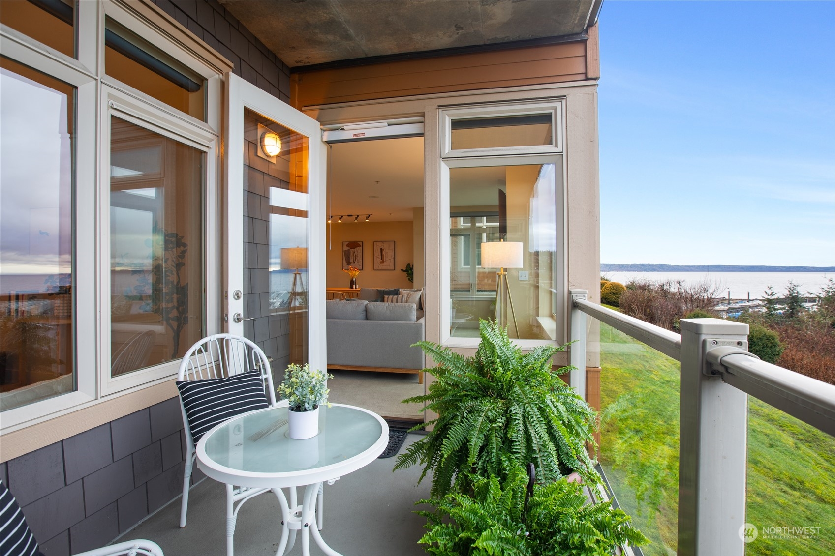 51 Pine Street, Unit 104 Edmonds, WA 98020 - Photo 30 of 40 a balcony with furniture and a potted plant