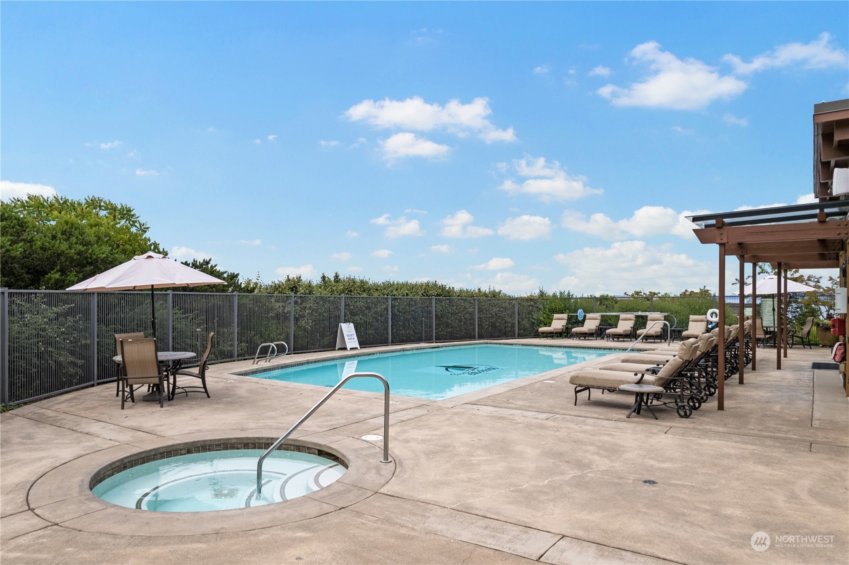 51 Pine Street, Unit 104 Edmonds, WA 98020 - Photo 39 of 40 a view of a swimming pool and lounge chair