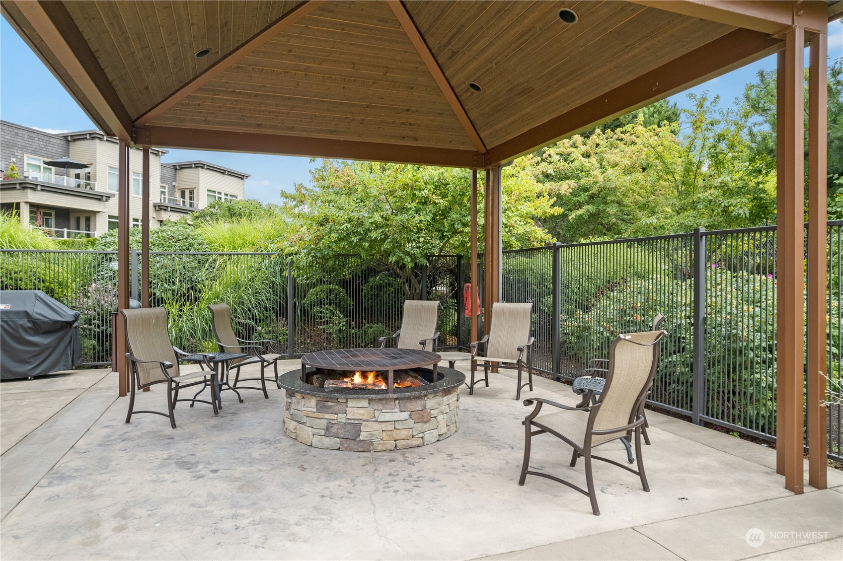 51 Pine Street, Unit 104 Edmonds, WA 98020 - Photo 40 of 40 a view of a patio with table and chairs and couches under an umbrella