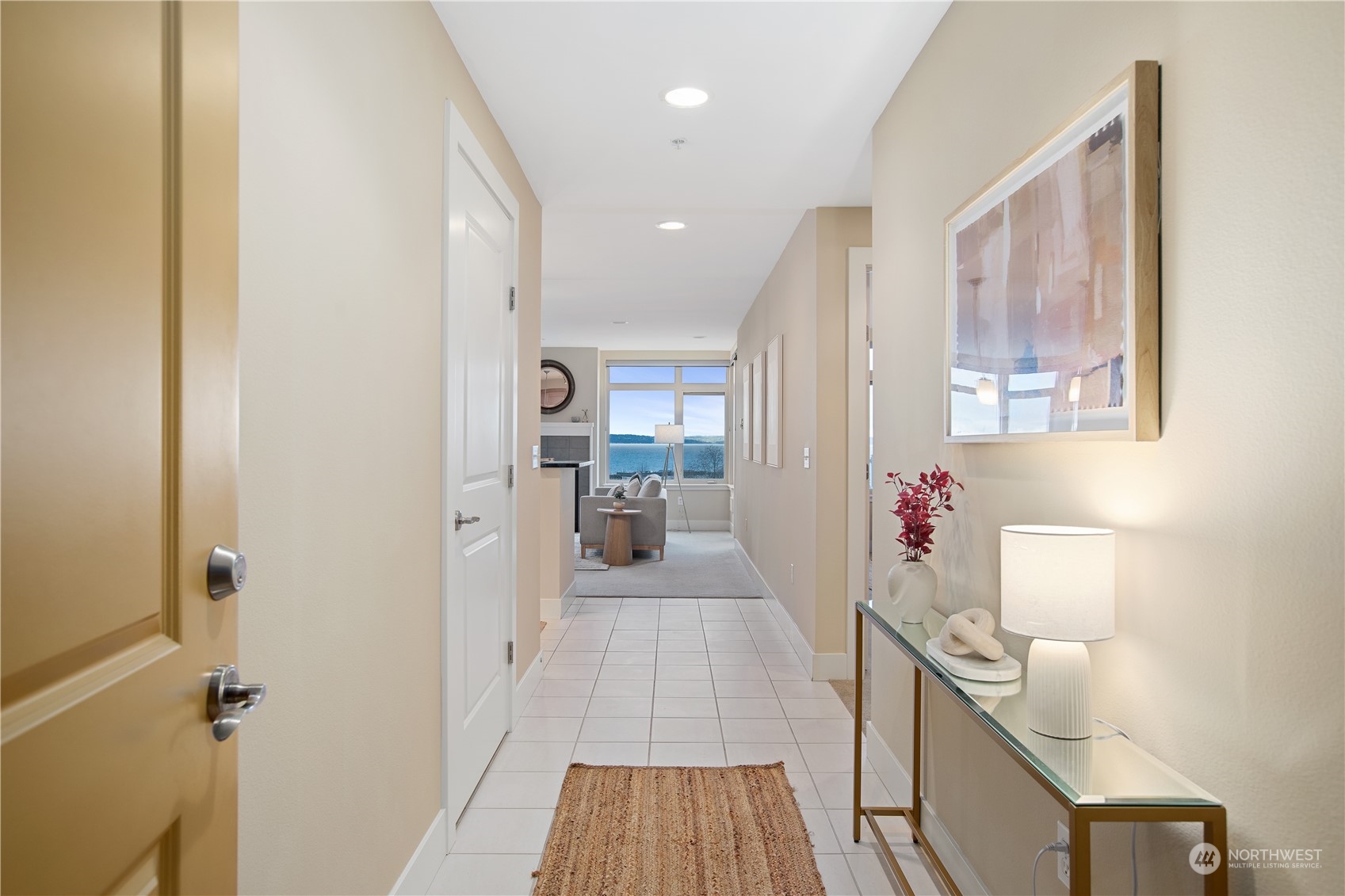 51 Pine Street, Unit 104 Edmonds, WA 98020 - Photo 4 of 40 a view of a hallway to a livingroom with wooden floor and windows
