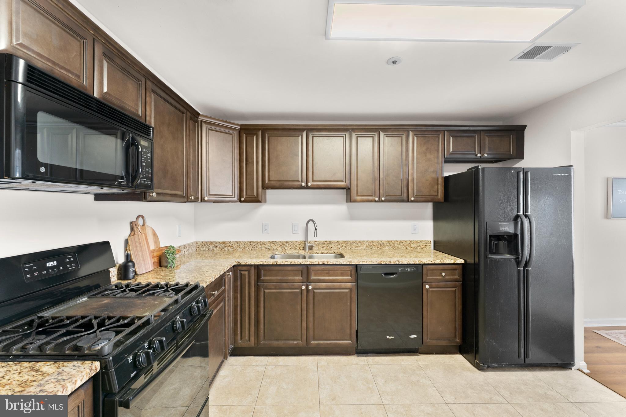 11184 Stagestone Way Manassas, VA 20109 - Photo 17 of 38 a kitchen with stainless steel appliances granite countertop a stove sink microwave and refrigerator