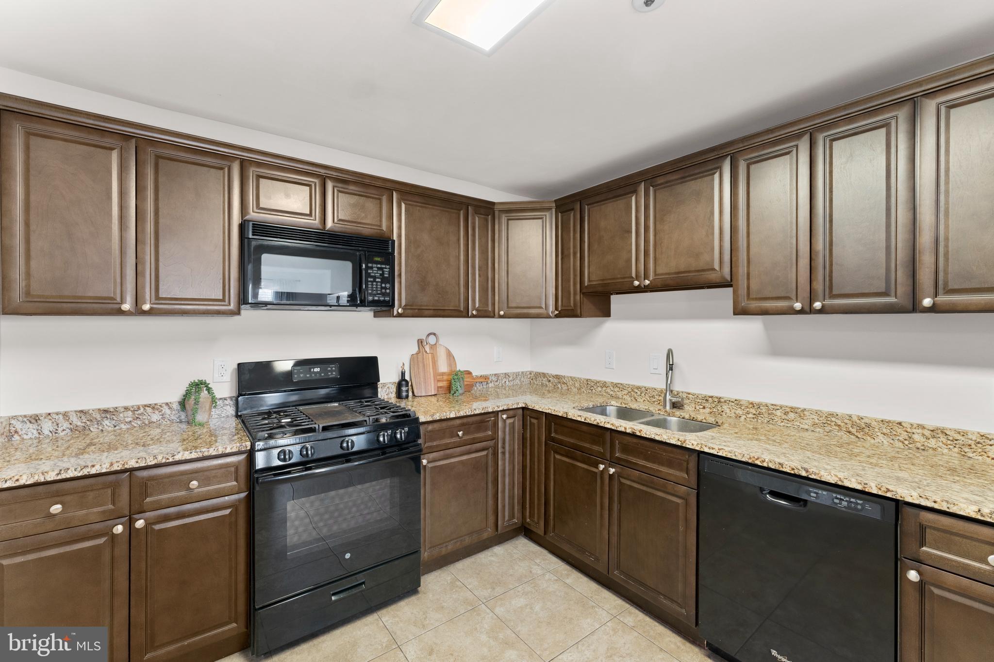 11184 Stagestone Way Manassas, VA 20109 - Photo 18 of 38 a kitchen with a sink stove top oven and cabinets