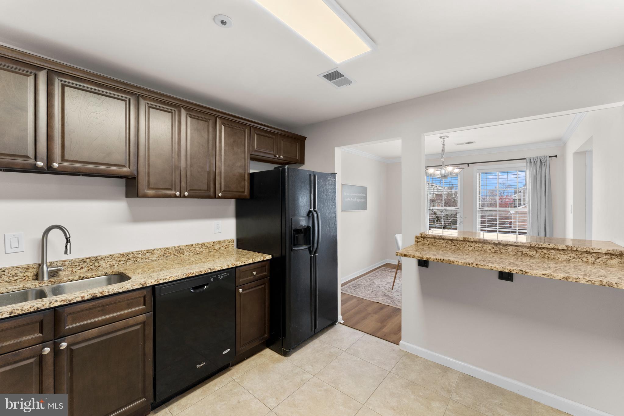 11184 Stagestone Way Manassas, VA 20109 - Photo 20 of 38 a kitchen with granite countertop a refrigerator and a sink