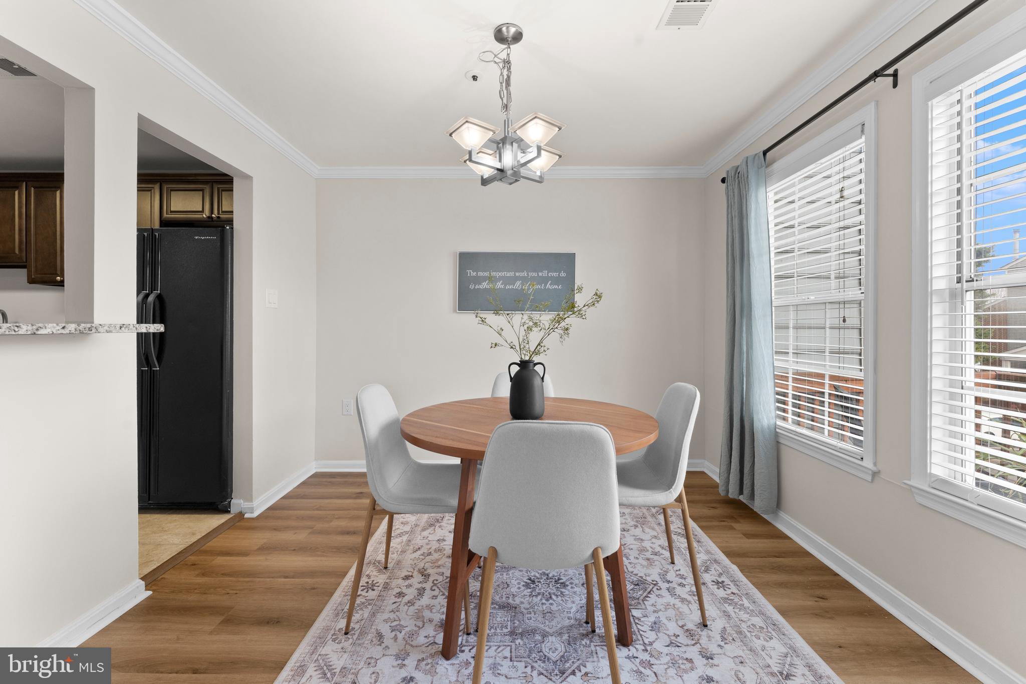 11184 Stagestone Way Manassas, VA 20109 - Photo 21 of 38 a dining room with furniture a chandelier and wooden floor