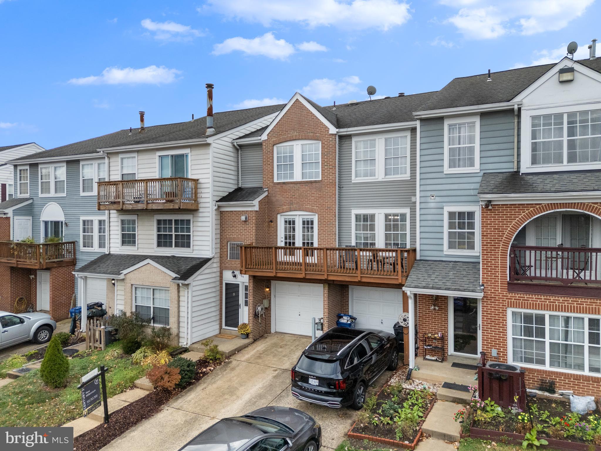 11184 Stagestone Way Manassas, VA 20109 - Photo 33 of 38 a front view of a residential apartment building with a yard