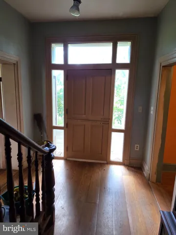 a view of front door with wooden floor