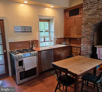 a kitchen with a stove a sink dishwasher and a refrigerator