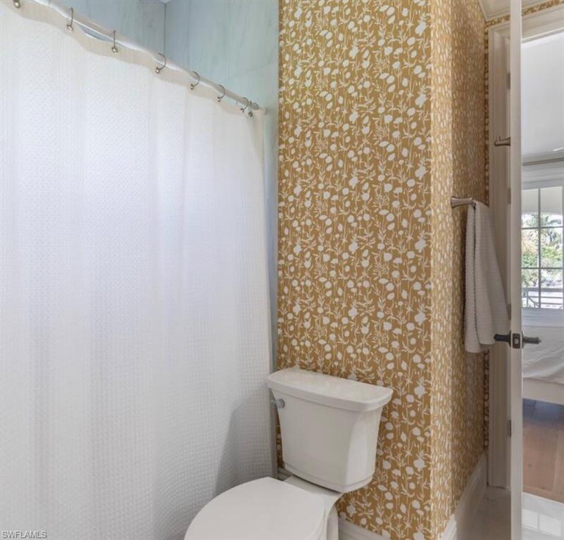 428 Rudder Road Naples, FL 34102 - Photo 41 of 49 Full bath featuring curtained shower and wallpapered walls