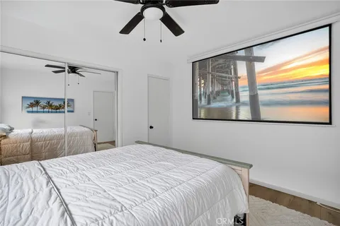 a bedroom with a large bed and a window