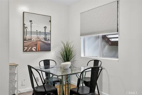 a view of a dining room with furniture and a potted plant