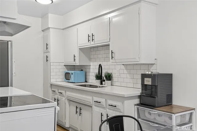 a kitchen with appliances cabinets and a counter top space