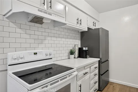 a kitchen with stainless steel appliances a stove and a microwave