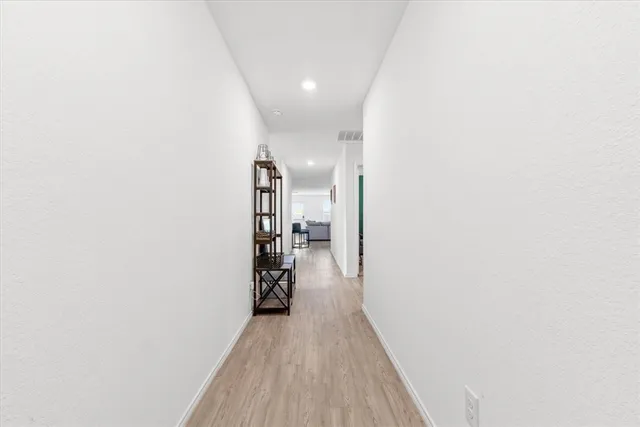 a view of hallway with wooden floor