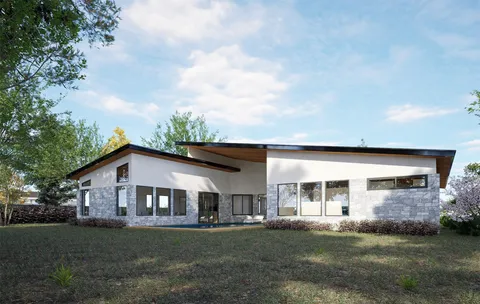 a front view of house with yard and trees