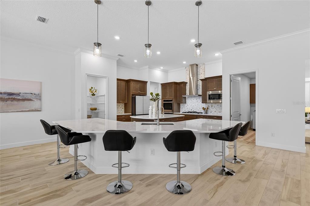994 Signet Drive Apollo Beach, FL 33572 - Photo 20 of 98 a kitchen with refrigerator and chairs