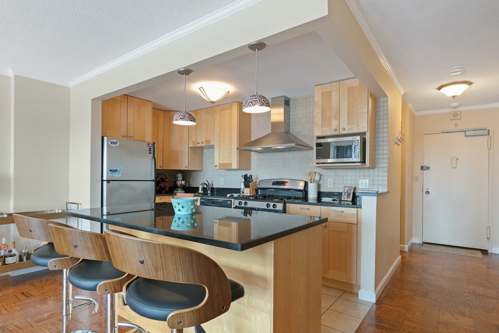 9 Hawthorne Place, Unit 9K Boston, MA 02114 - Photo 12 of 22 a kitchen with stainless steel appliances granite countertop a sink stove and refrigerator