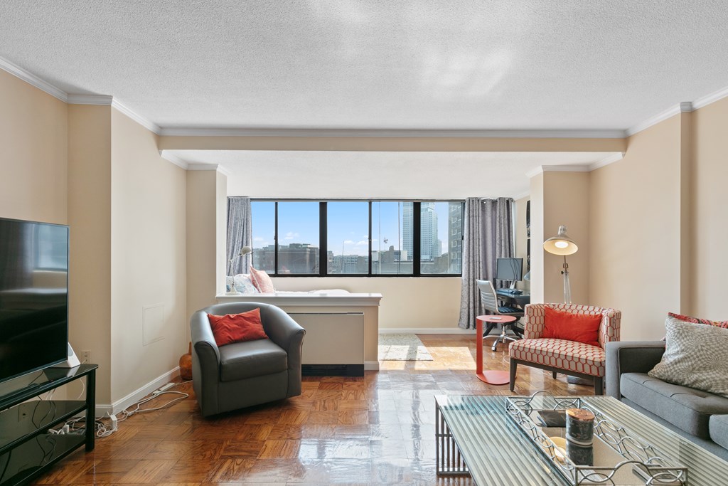 9 Hawthorne Place, Unit 9K Boston, MA 02114 - Photo 2 of 22 a living room with furniture and a flat screen tv