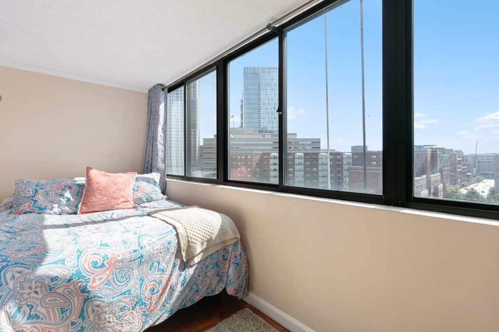 9 Hawthorne Place, Unit 9K Boston, MA 02114 - Photo 9 of 22 a bedroom with a bed and a large window