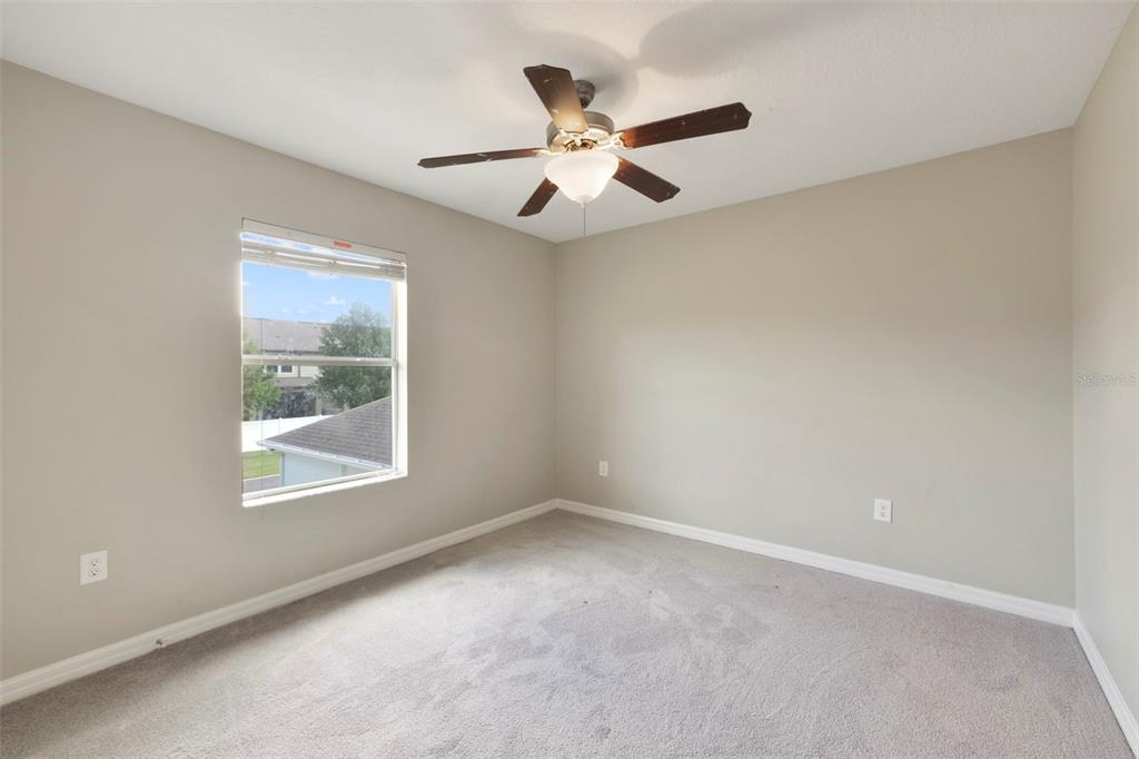 1209 Seburn Road Apopka, FL 32703 - Photo 14 of 25 an empty room with window and ceiling fan
