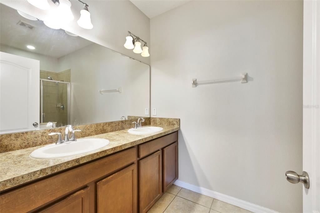 1209 Seburn Road Apopka, FL 32703 - Photo 16 of 25 a bathroom with a granite countertop sink and a mirror