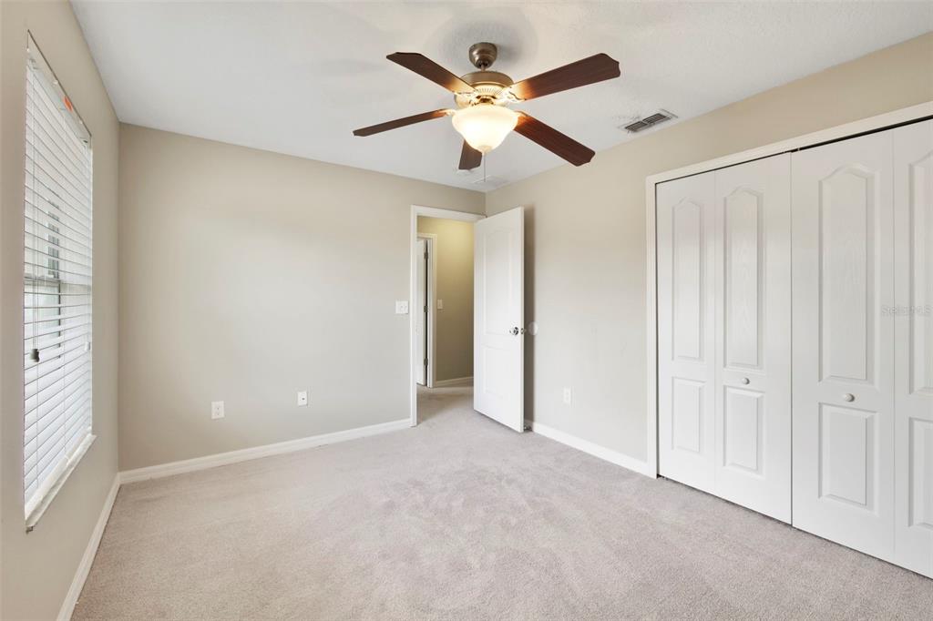 1209 Seburn Road Apopka, FL 32703 - Photo 17 of 25 an empty room with ceiling fan and window