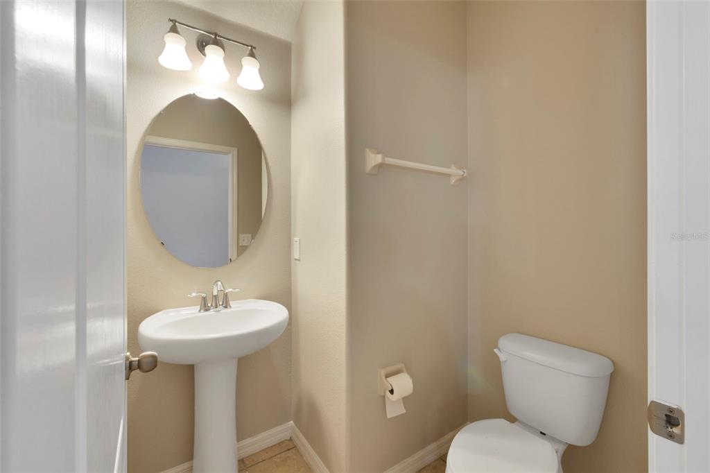 1209 Seburn Road Apopka, FL 32703 - Photo 19 of 25 a bathroom with a toilet sink and mirror